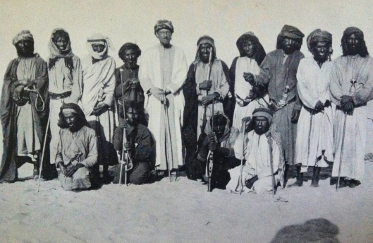 The European explorer Bertram Thomas pictured with some "pure" Arabs. The deeply pigmented, near black color of these individuals approximates that of the earliest Semites. This is because, prior to contact with European-related peoples bearing Anatolian Neolithic ancestry and peoples from the Iranian plateau/Caucasus bearing Caucasus Hunter-Gatherer ancestry, the pre-Proto-Semities, who, descended from the Natufians, did not bear any alleles associated with lighter coloration.